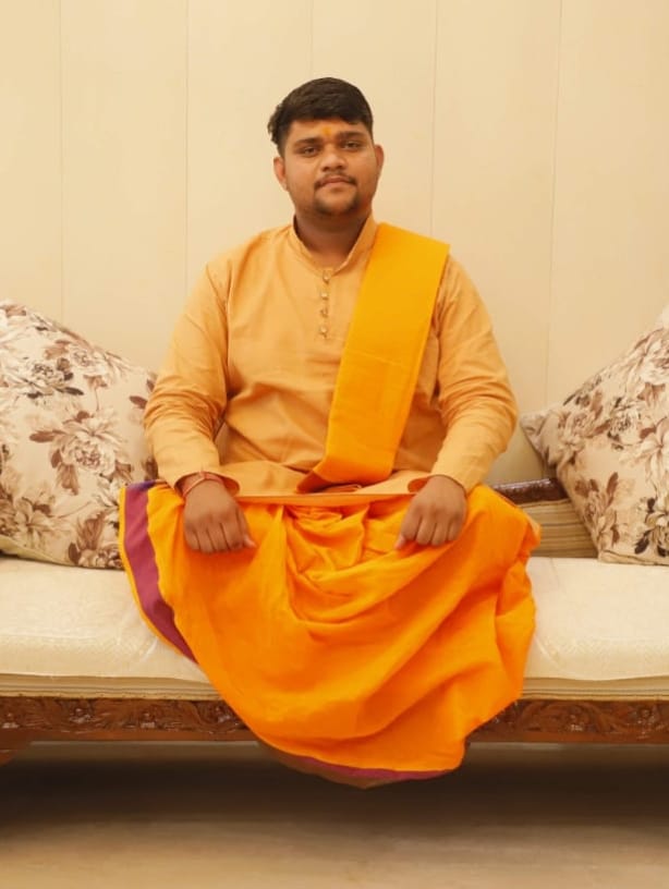 Pandit performing a puja ceremony with sacred fire and offerings