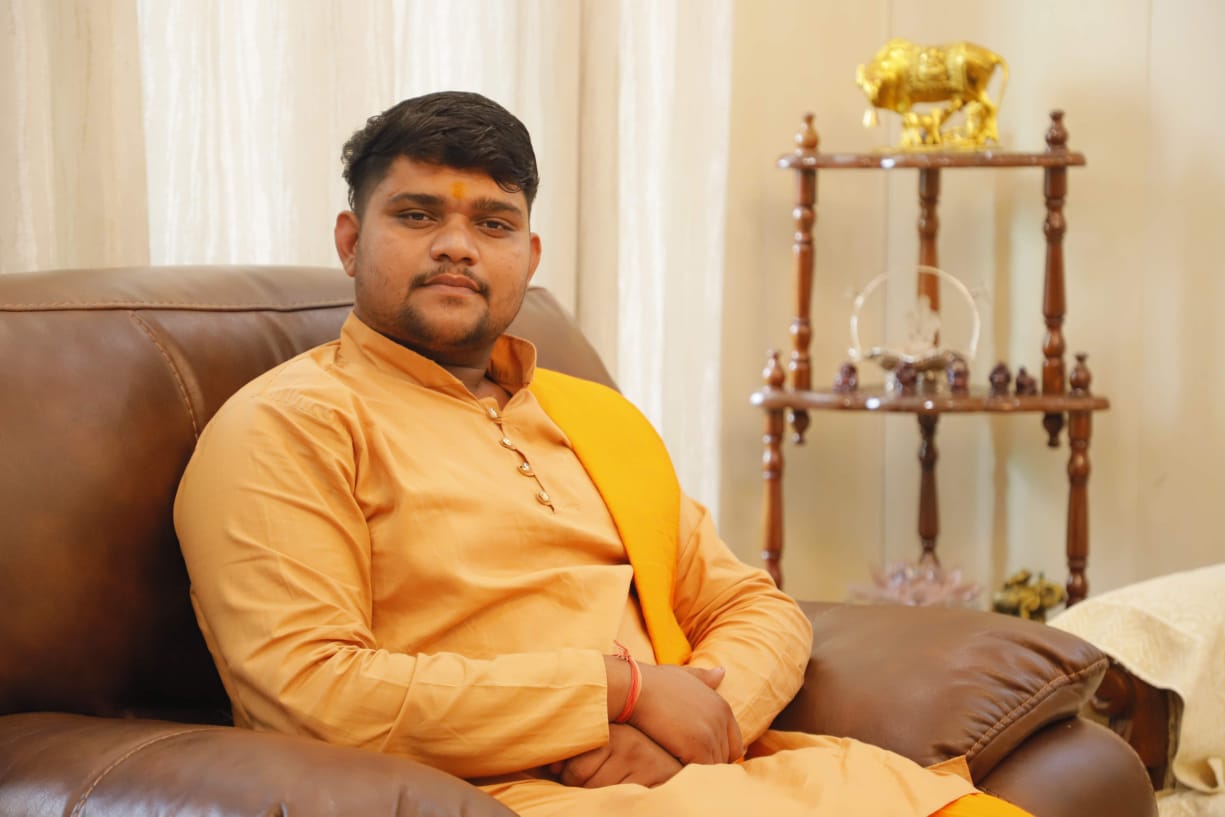 Pandit performing a puja ceremony with sacred fire and offerings